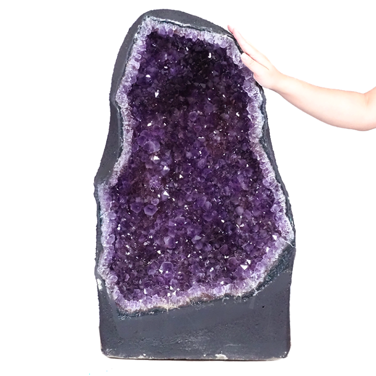 Crystal cave amethyst with deep purple clustered points and a raw natural outer shell.