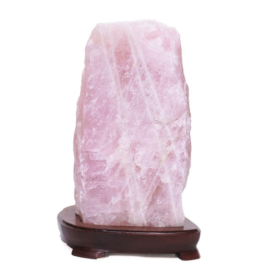 Stone lamp with soft pink glow, made from rose quartz.